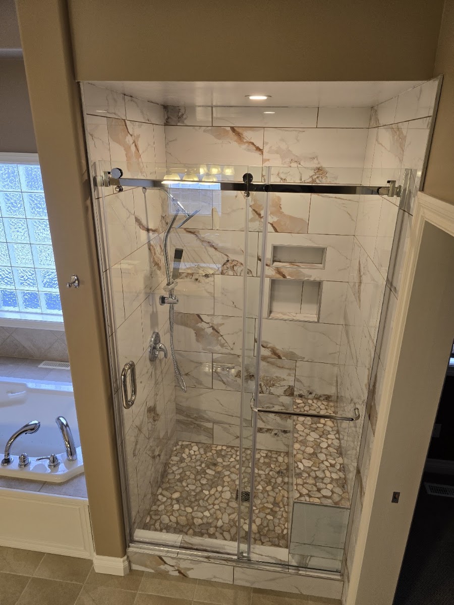 Finished bathroom renovation with new tile work and modern fixtures by Eve's Contracting