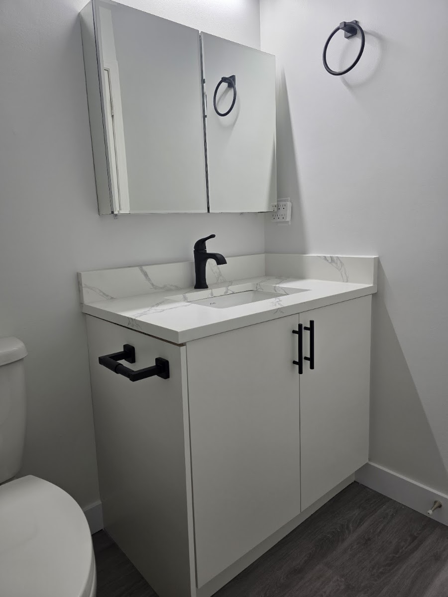 Bathroom drywall and paint work with smooth finish ready for fixtures